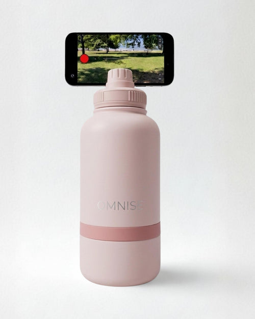 Pink water bottle with smartphone on a white background