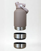 Brown insulated bottle with detachable water and dog food bowls on a light gray background