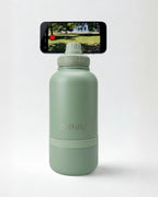 Green water bottle with smartphone displaying a video on a white background