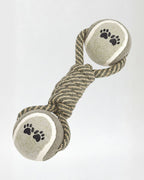 Pet toy with rope and ball on a light gray background