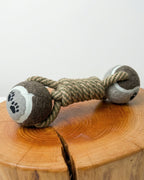 Dog toy with rope and paw pattern on a wooden surface